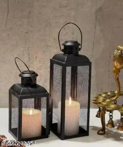 Two black metal lanterns with mesh sides  